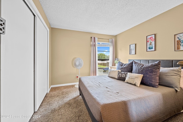 bedroom featuring a closet, a textured ceiling, and carpet flooring