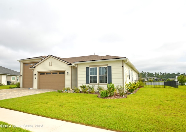 view of front of home with a garage and a front lawn