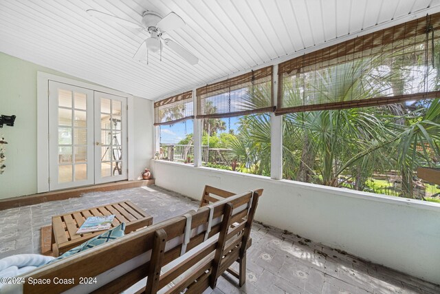 sunroom featuring ceiling fan and french doors