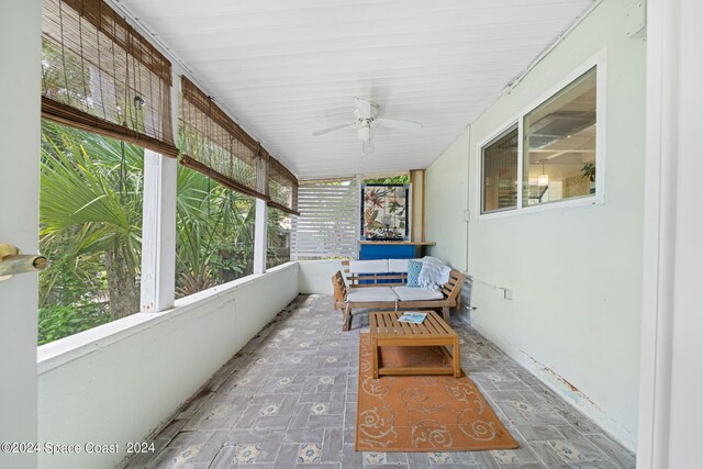 sunroom / solarium featuring a wealth of natural light and ceiling fan