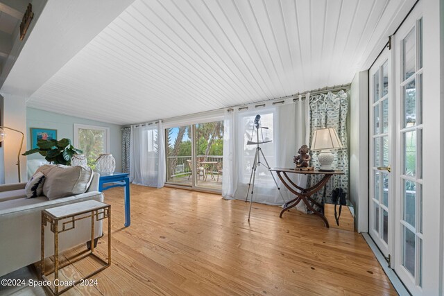 sunroom featuring vaulted ceiling, a wealth of natural light, and wood ceiling