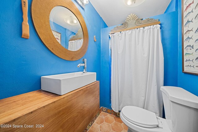 bathroom featuring tile patterned flooring, vanity, and toilet