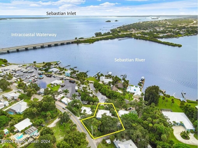 birds eye view of property with a water view