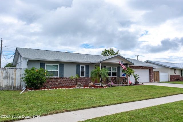 ranch-style home featuring a garage and a front lawn