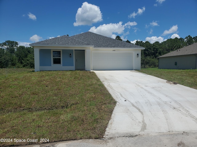 single story home featuring a front yard and a garage