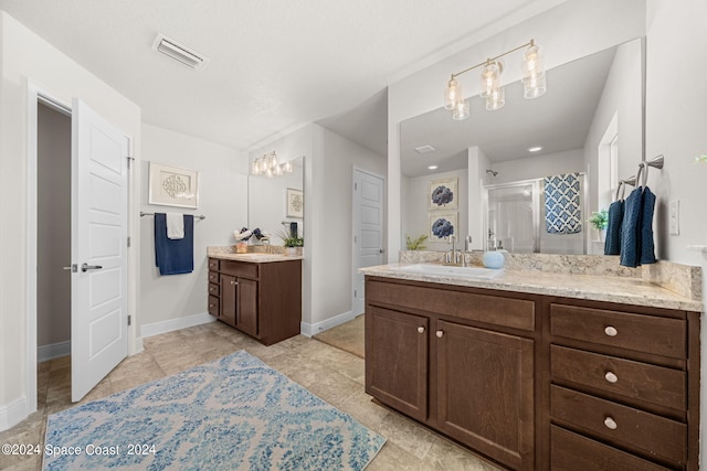 bathroom with vanity, an enclosed shower, and tile patterned flooring