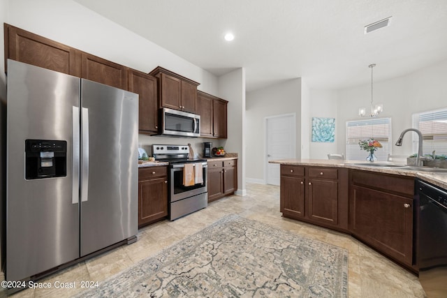 kitchen with pendant lighting, a notable chandelier, appliances with stainless steel finishes, sink, and dark brown cabinetry