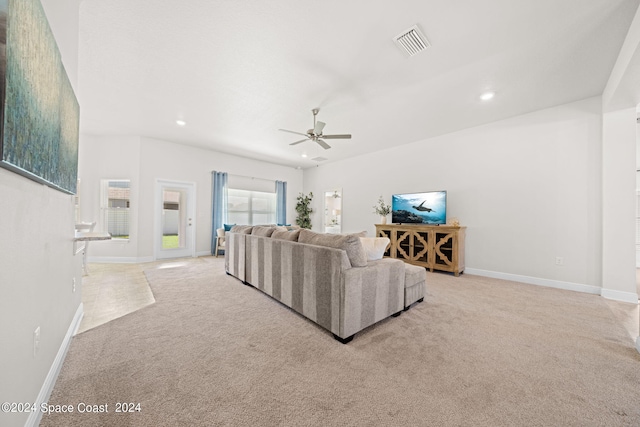 carpeted living room with ceiling fan