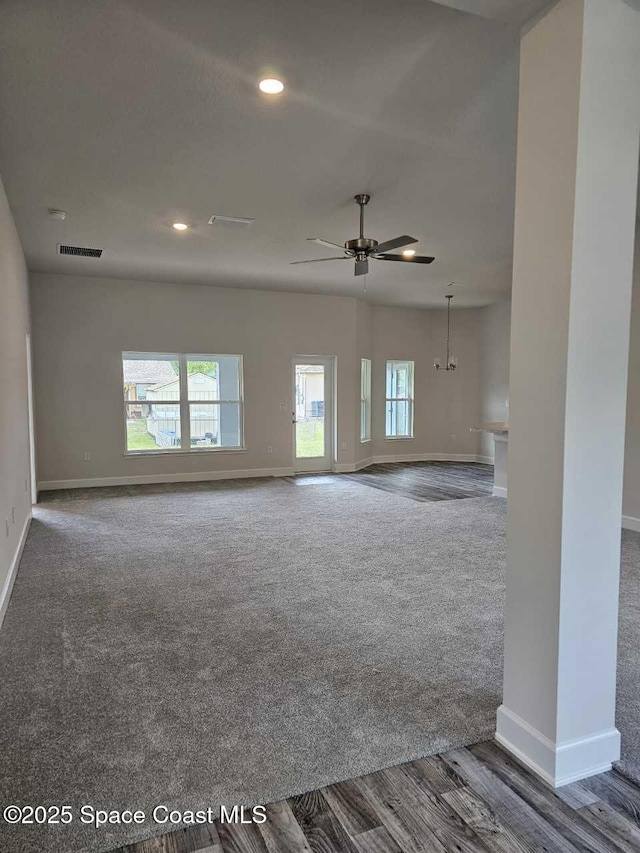 unfurnished living room featuring carpet, a ceiling fan, visible vents, recessed lighting, and baseboards