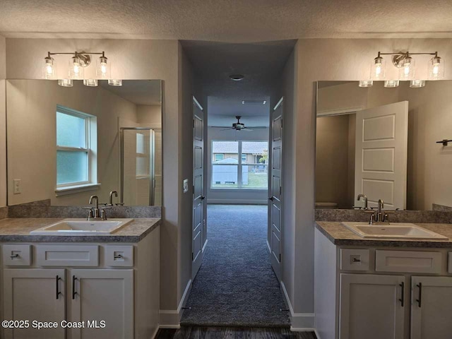full bathroom featuring a sink, a ceiling fan, and a textured ceiling