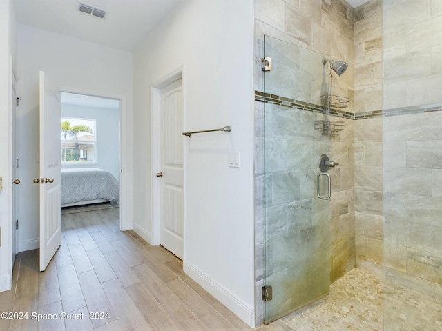 bathroom featuring a shower with shower door