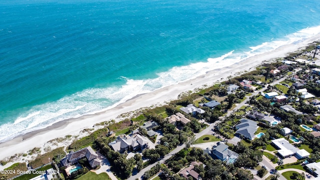 bird's eye view with a water view and a view of the beach