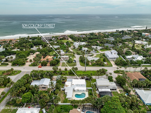 bird's eye view featuring a water view and a beach view