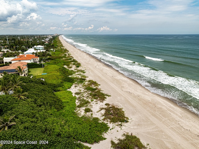 birds eye view of property with a beach view and a water view