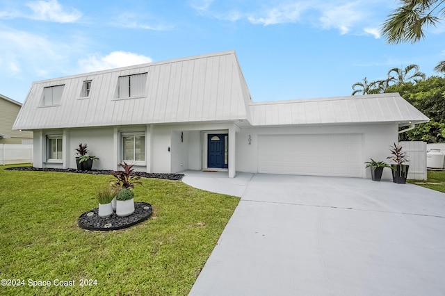 view of front of house featuring a garage and a front yard