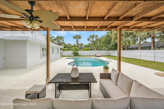 view of pool with outdoor lounge area, a patio area, and ceiling fan