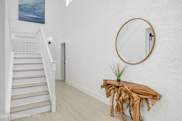 staircase with hardwood / wood-style floors