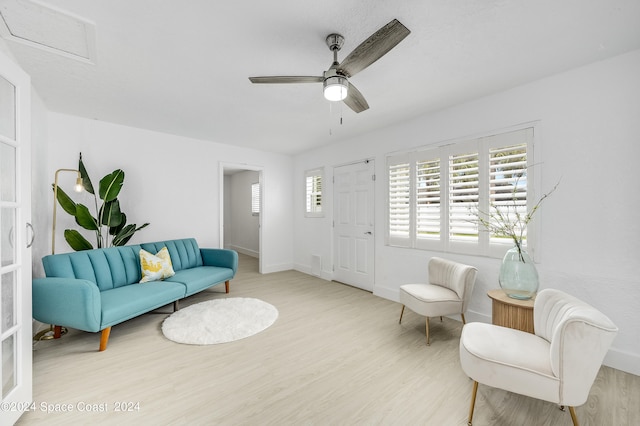 sitting room featuring ceiling fan and light wood-type flooring