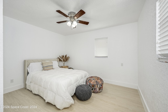 bedroom with ceiling fan and light hardwood / wood-style floors