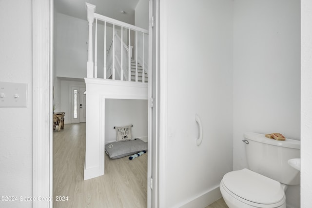 bathroom with hardwood / wood-style floors and toilet