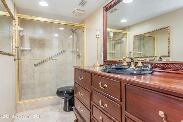 bathroom featuring tile patterned flooring, vanity, toilet, and walk in shower