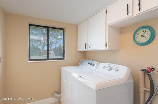 laundry area with cabinets and washing machine and dryer