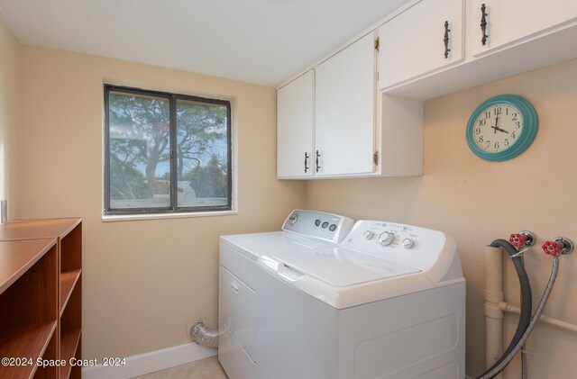 laundry area with cabinets and separate washer and dryer