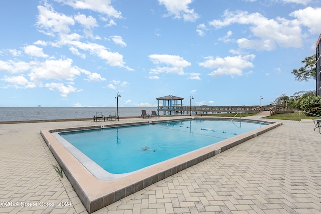 view of swimming pool with a water view