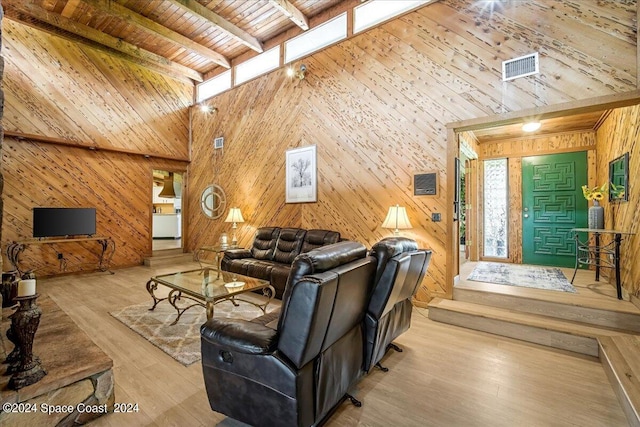 living room with wood ceiling, wooden walls, and light hardwood / wood-style floors