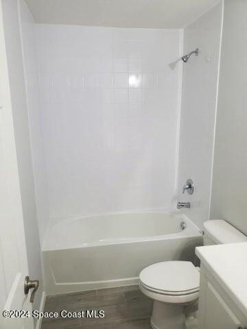 full bathroom with vanity, toilet, shower / washtub combination, and hardwood / wood-style floors