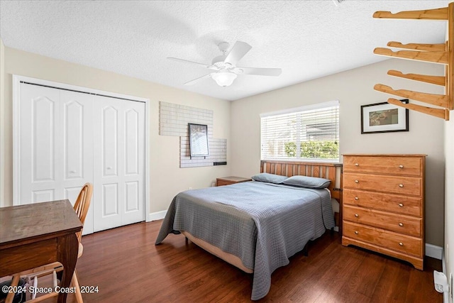 bedroom featuring a textured ceiling, ceiling fan, a closet, and dark hardwood / wood-style flooring