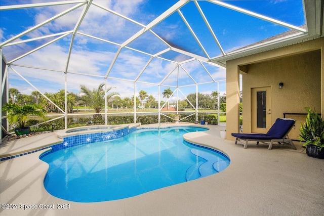 view of swimming pool with a lanai, a patio, and an in ground hot tub