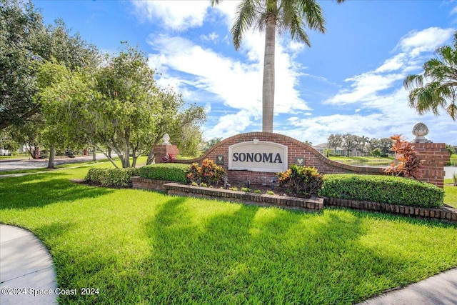 community / neighborhood sign featuring a yard