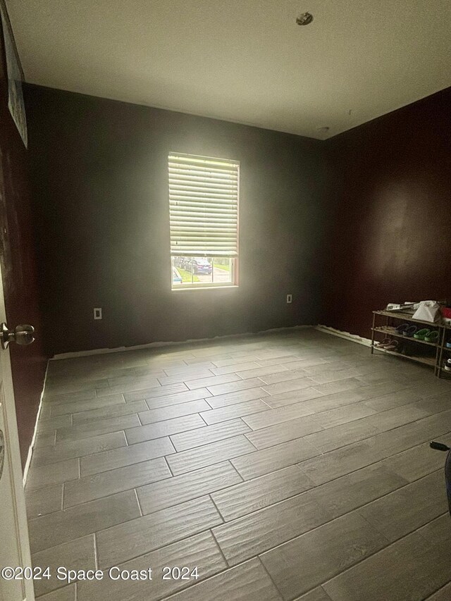 unfurnished room featuring a textured ceiling and hardwood / wood-style flooring