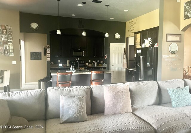 kitchen featuring black appliances and decorative light fixtures