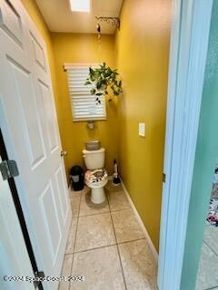 bathroom with tile patterned flooring and toilet