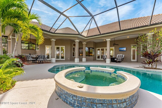 view of pool with an in ground hot tub, a patio, a lanai, french doors, and ceiling fan