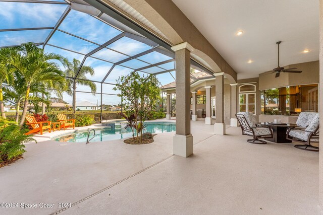 view of patio with ceiling fan and a lanai