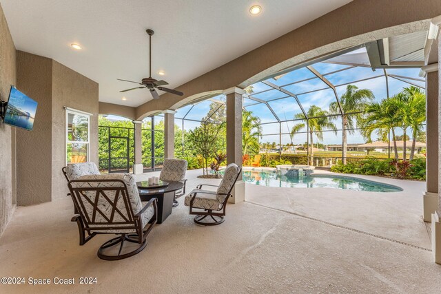 view of patio featuring ceiling fan and a lanai