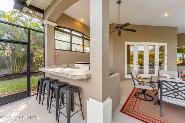 sunroom with lofted ceiling and ceiling fan