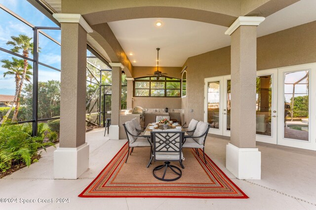 view of patio / terrace featuring french doors, glass enclosure, and an outdoor hangout area