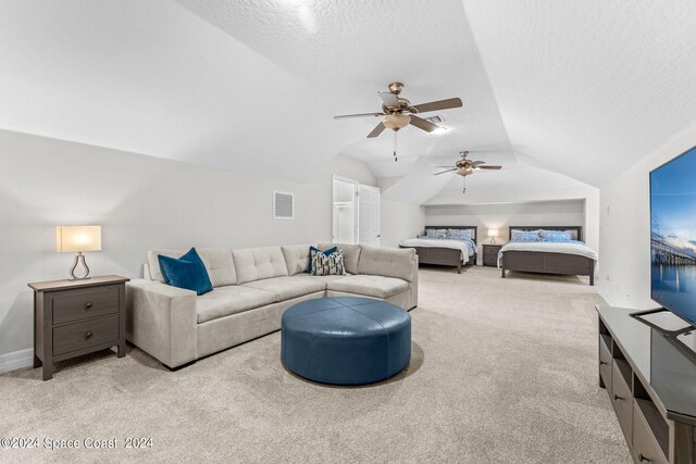 carpeted living room featuring ceiling fan, a textured ceiling, and vaulted ceiling