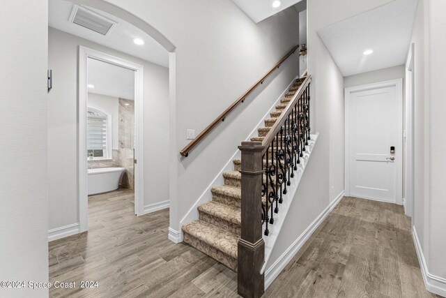 stairway featuring hardwood / wood-style floors