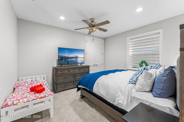 bedroom featuring ceiling fan and light colored carpet