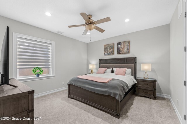 bedroom with light colored carpet and ceiling fan