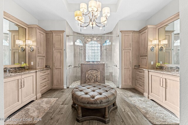 sitting room featuring a notable chandelier, sink, and light wood-type flooring