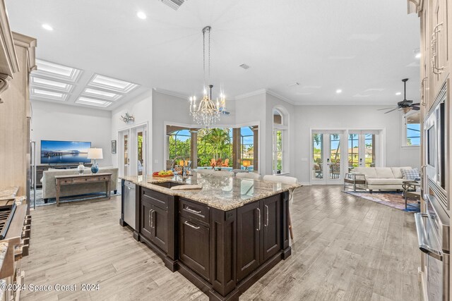 kitchen featuring a healthy amount of sunlight, ceiling fan with notable chandelier, and french doors