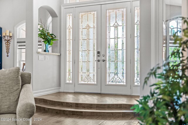 entryway with french doors and hardwood / wood-style floors