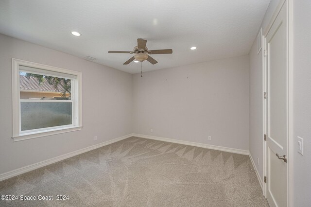 unfurnished bedroom with ceiling fan and carpet