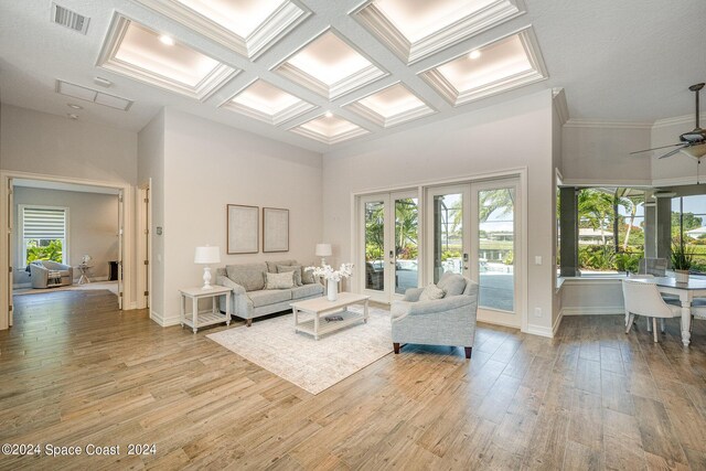 living room with light hardwood / wood-style flooring, ceiling fan, plenty of natural light, and french doors